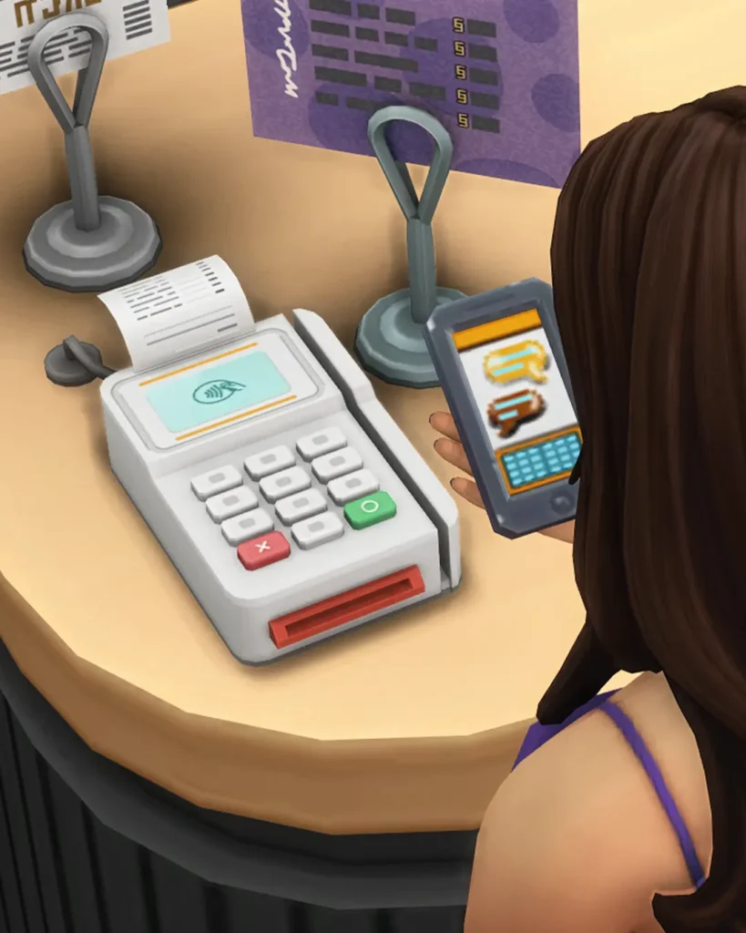 Sims 4 CC functional payment terminal mod by SixamCC on a retail or café counter for realistic checkout gameplay.